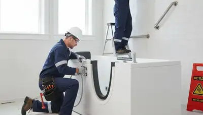 Providence, RI plumber installing a walk-in tub for safer, accessible bathing in a home bathroom